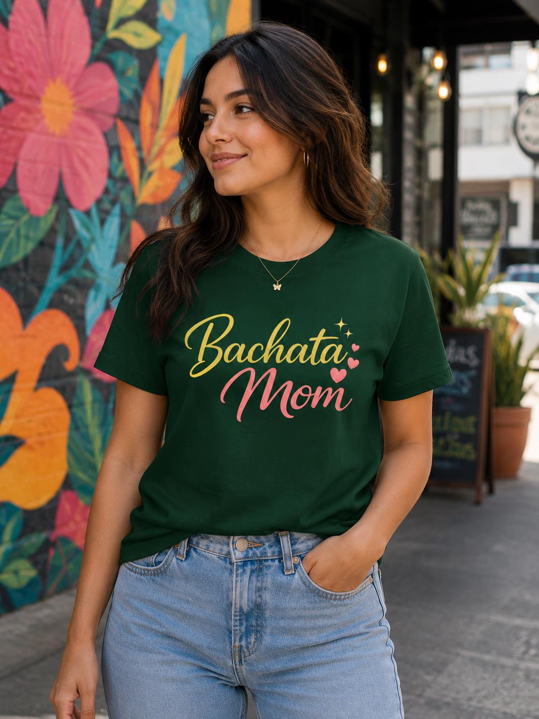 Female model wearing green Bachata Mom salsa dance t-shirt with colorful lettering, casual Latin dance fashion apparel for bachata lovers and dance moms.